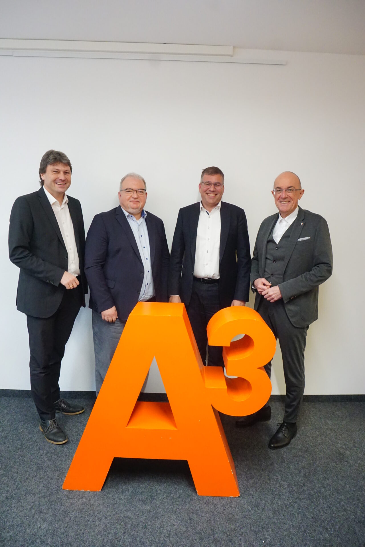 Der Aufsichtsratsvorsitzende von A³ , Dr. Wolfgang Hübschle (2. von rechts, Wirtschaftsreferent der Stadt Augsburg), Landrat Dr. Klaus Metzger, Landkreis Aichach-Friedberg (rechts), und der stellvertretende Landrat Dr. Michael Higl, Landkreis Augsburg (links) gehörten zu den ersten Gratulanten für die Vertragsverlängerung von Andreas Thiel.